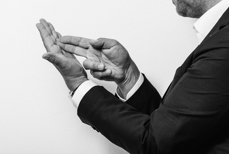 Es sind nur die Hände und Arme von Martin Scheinert abgebildet. Zeige- und Mittelfinger der rechten Hand zeigen auf die Handinnenfläche der linken Hand.